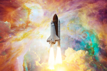 Spaceship flight. Space shuttle with smoke and blast takes off into the starry sky and clouds of...