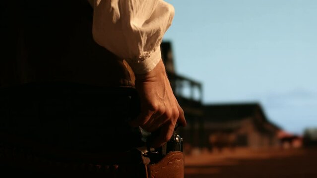 Cowboy preparing to draw his gun during standoff, CU on hands and holster. Spaghetti, macaroni western style cinematic footage