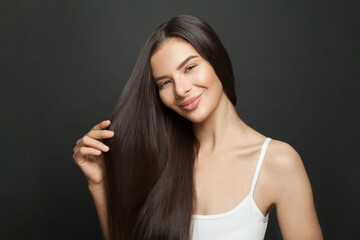 Beautiful long hair. Beauty woman with straight black hair on dark background