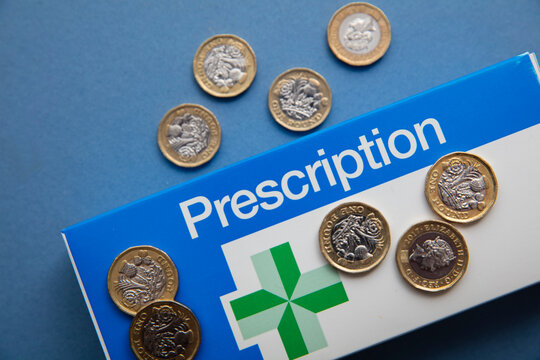 OXFORD, UK - May 2022: NHS medical prescription packaging with money. Healthcare cost concept
