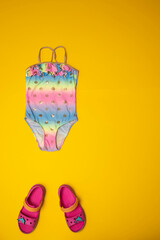 Summer vacation flatlay kids swimsuit and beach sandals
