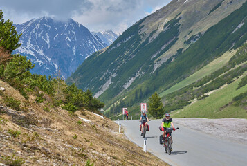 Fototapeta na wymiar group of three active seniors riding Their electric mountain bikes up to Hahntenn Joch Pass in Tirol, Austria