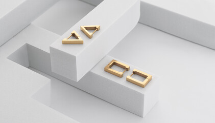 Geometric shape modern golden earrings on white geometric forms with copy space