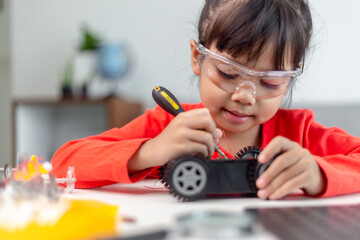 Asia students learn at home in coding robot cars and electronic board cables in STEM, STEAM, mathematics engineering science technology computer code in robotics for kids concept.