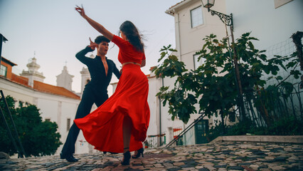 Beautiful Couple Dancing a Latin Dance on the Quiet Street of an Old Town in a City. Sensual Dance by Two Professional Dancers on a Sunny Day Outside in Ancient Culturally Rich Tourist Location. - obrazy, fototapety, plakaty
