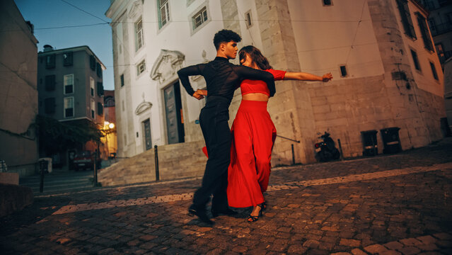 Beautiful Couple Dancing A Latin Dance On The Quiet Street Of An Old Town In A City. Sensual Dance By Two Professional Dancers In The Evening In Ancient Culturally Rich Tourist Location.