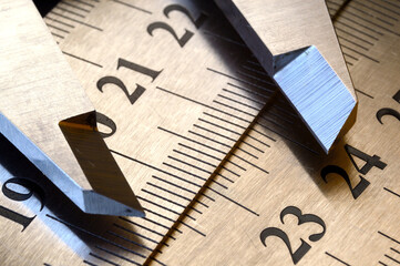 Accurate measuring tool caliper and metal ruler lie on top of each other. close-up.