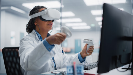 Futuristic Medical Hospital: Black Female Neurosurgeon Wearing Virtual Reality Headset Uses...
