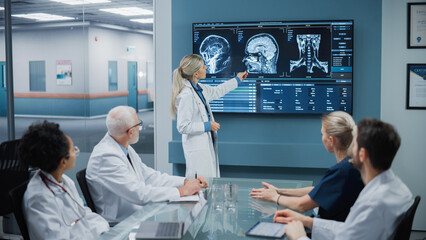 Hospital Conference Meeting Room: Female Physician Presents Patient X-Ray on TV Screen, Team of Medical Doctors Discuss Patient Treatment. Research Scientists Talk of Cure, Drug, Medicine Development - obrazy, fototapety, plakaty