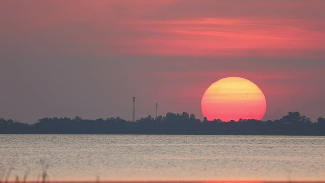 Red sun touches the horizon.Fantastic natural sunsets