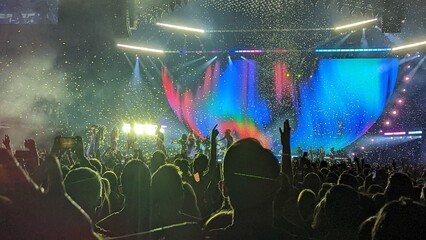 crowd at music concert with confetti 