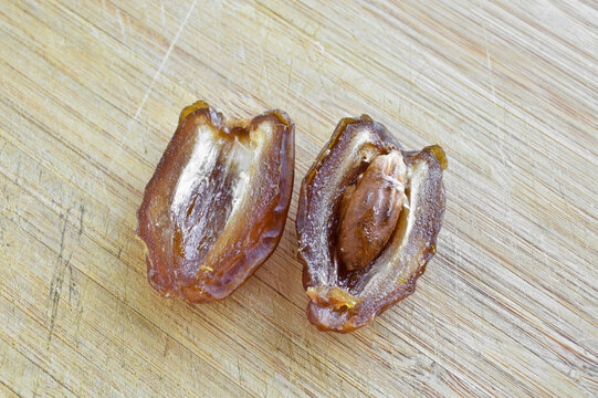 Organic fresh nutritious dried hurma dates medjool grains, on cutting board