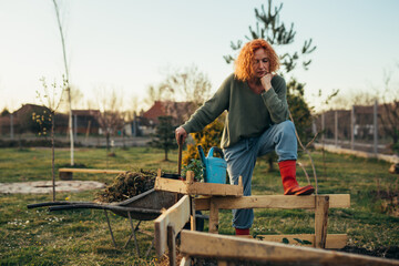 woman finished with planting flowers in backyard