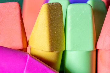 Macro image of colorful pencil erasers arranged in random patterns. Good backdrop concept. - obrazy, fototapety, plakaty