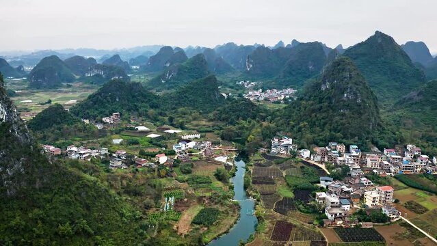 Aerial shot of the amazing rock formations rural towns near the Li River in Yangshuo County China. Hazy day.