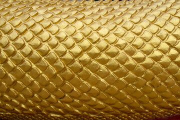 Abstract gold yellow serpent scale statue texture