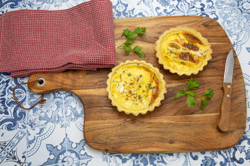top view of cheese tartlets on wooden board