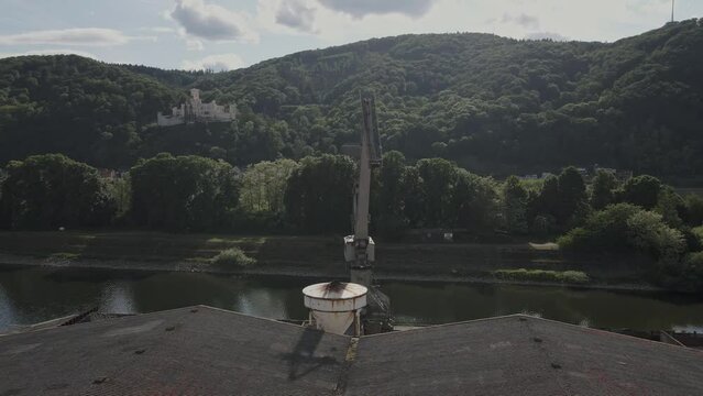aerial images of a heavy crane at an industrial building in Lahnstein on the river Rhine in Germany with the castle in the background
