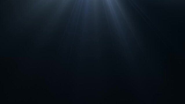 Looped animated blue light rays on dark background