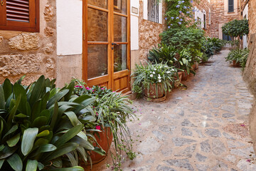 Traditional stone house facade decorated with plants in Mallorca, Spain