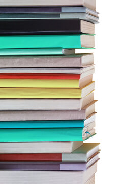 Vertical stack of different colorful books on white background. Copy space