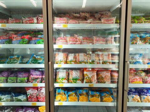 SELANGOR, MALAYSIA -MARCH 5, 2022: Pastries and frozen food in a chiller. On display for sale in -store. The freezer has glass on the front to make it easier for customers to make a choice.