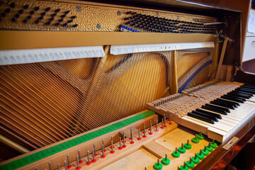 Disassembled upright piano for regulation, cleaning, repair. Interior of a piano. Piano keys...