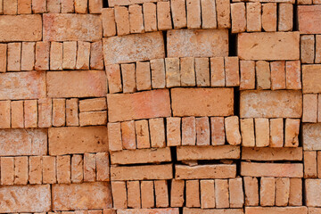 Stacked of orange bricks for building constuction