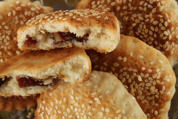 Date filled pastry with sesame, close up on pastry with sesame known as ‘kombe’ in Hatay, Turkey.