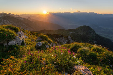 Sunrise mountains silhouette in the Julian Alps. Beautiful morning at the summit of the hills. 