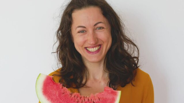 Smiling girl eating watermelon, woman holding watermelon slice