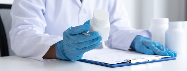 Closeup portrait, Scientists in white lab coats are analyzing the vital substance of the sample...