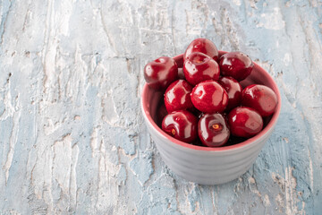 delicious cherry fruits in a gray bowl on table