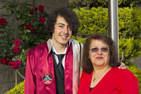 Happy Family Smiling At Camera In Graduation Party