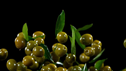Freeze motion of flying green olives.