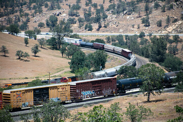 Tehachapi Loop where Trains Cross over themselves to Climb a Steep Grade with 2 Trains Crossing...