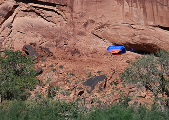 Handglides float down from the sky against colorful rock. - 505939100