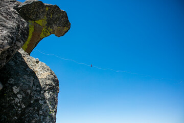 A Woman Walking a Tight Wire with the sky Behind Her