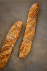Fresh baguette with crispy crust on a concrete table