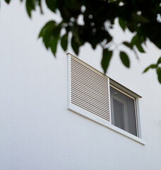 Facade of a modern house. Window protected by a security camera. House under video surveillance to...