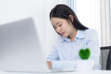 Asian woman is studying online via the internet with a cheerful smile, stay home, New normal, Covid-19 coronavirus, Social distancing, Internet learning.