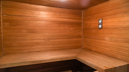 Traditional finnish sauna made from wood. Empty interior of wooden spa cabin with hot dry steam.