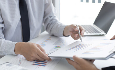 Meeting a team of businessmen, Executives and accountants meeting about the company's revenue graph in the office with laptops and calculators, Finance concept.