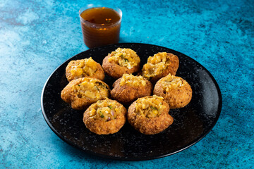 Pakistani spicy gol gappay, indian pani puri and bangali fuchka full of chaat masala with sour water in a dish isolated on marble background top view of indian street food