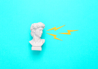 David bust with sparks from the eyes on a turquoise background. minimal concept. Pop Art