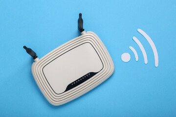 Paper cut Waves wi-fi icon and Wi-Fi router on blue background. Top view