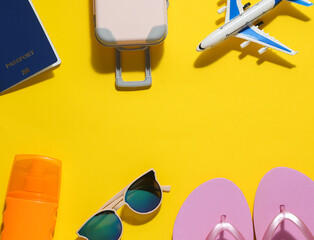 Summer time. Resort, beach vacation, traval concept. Travel accessories on yellow background. Top view. Copy space