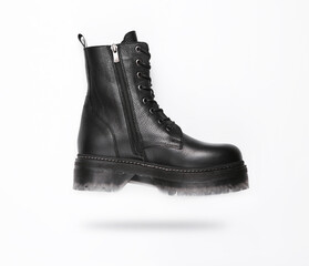 Soaring Fashionable stylish leather female boot on white background with shadow.