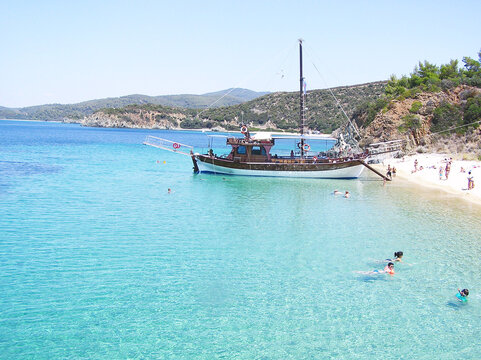 turquoise sea, ship in Toroni bay, Greece