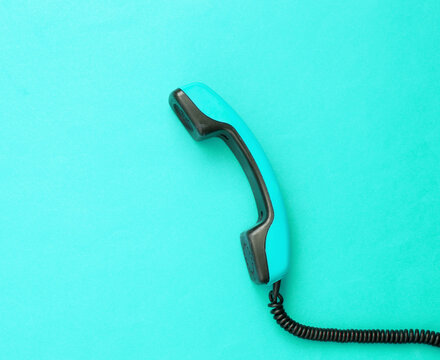 Retro cable phone tube on blue background. Top view